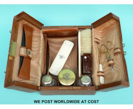 A leather Shadwell and Kerton Vanity case with contents including hallmarked silver gilt mounted bottles, ivory items, pin cu