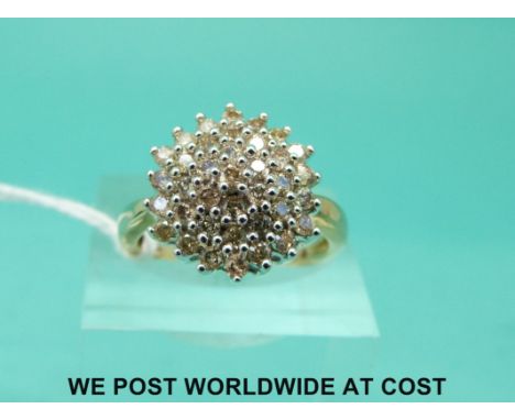 A yellow metal ring marked 9k set with diamonds in a cluster (size O)