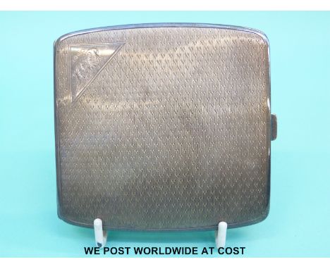 A hallmarked silver cigarette case with engine turned decoration (136g)