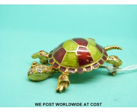 A yellow metal brooch in the form of a tortoise set with green and red enamel to the body and diamonds to the head, indistinc