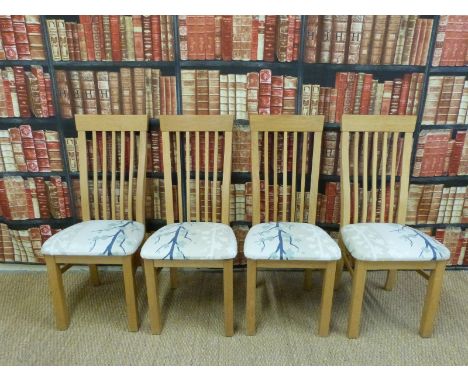 Four upholstered light oak chairs