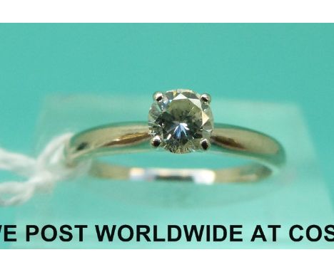 A white metal ring marked 14k set with a round brilliant cut diamond of approximately 0.3ct (size K)