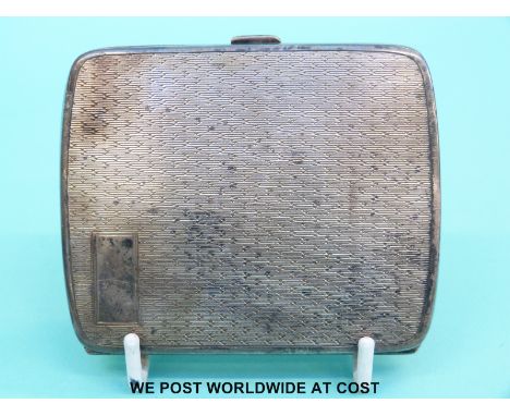 A hallmarked silver cigarette case with engine turned decoration (106g)