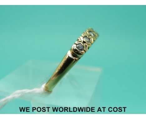 A 9ct gold ring set with seven diamonds in a row (size N)