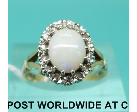 A 9ct gold ring set with an oval opal cabochon surrounded by diamonds (size M)