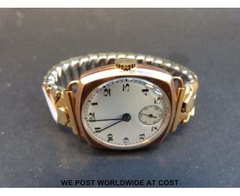 A cushion shaped 9ct gold gentleman's wristwatch with blued hands, subsidiary seconds dial and white enamel face, on expandin