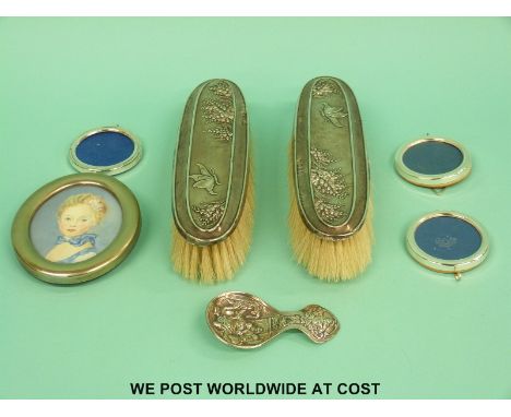 A pair of hallmarked silver-backed brushes and three small circular photo frames, together with a further plated frame and ca