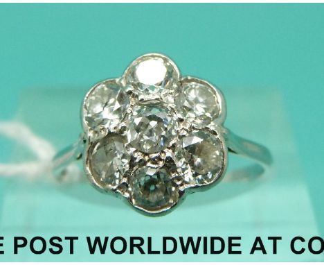 A platinum ring set with a central diamond of approximately 0.2ct surrounded by six further diamonds, each approximately 0.2c