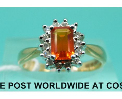 An 18ct gold ring set with a fire opal surrounded by diamonds (size L)