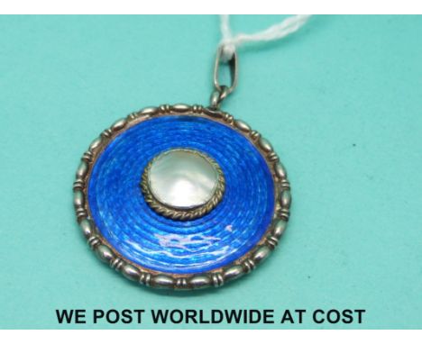 A Charles Horner hallmarked silver circular pendant set with blue guilloche enamel with mother of pearl roundel to the centre