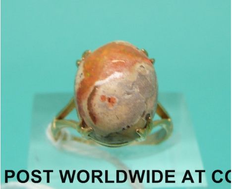 A 9ct gold ring set with an opal boulder cabochon (size K)