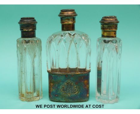 A Victorian hallmarked silver gilt and cut glass hip flask and two matching bottles, the hip flask with pull off cup, all thr