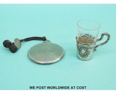 A hallmarked silver compact with engine turned decoration and a white metal mounted drinking glass, stamped 800
