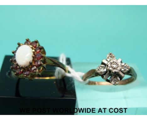 A 9ct gold ring set with diamonds (size J) and a 9ct gold ring set with an opal and garnets (size J)