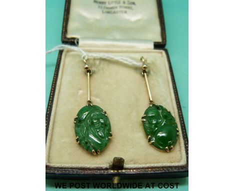 A pair of yellow metal earrings set with carved jade panels, in original fitted box 