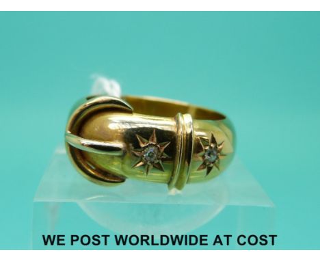 An 18ct gold buckle ring set with two diamonds (size P)