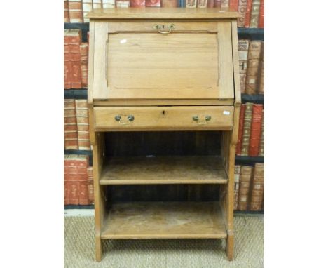 A light oak Art Nouveau students bureau bookcase with single drawer and pierced decoration to the sides (H109xW65xD37cm)