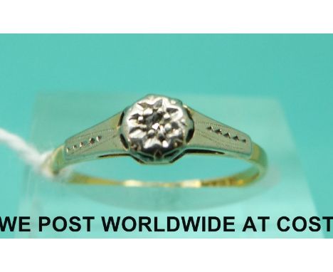 An 18ct gold ring set with a diamond in a platinum setting (size M)