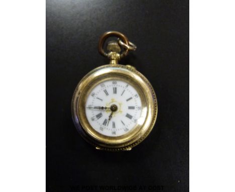 An 18ct gold ladies fob watch with Roman numerals and gilt detail to the white enamel face, case diameter 28mm 