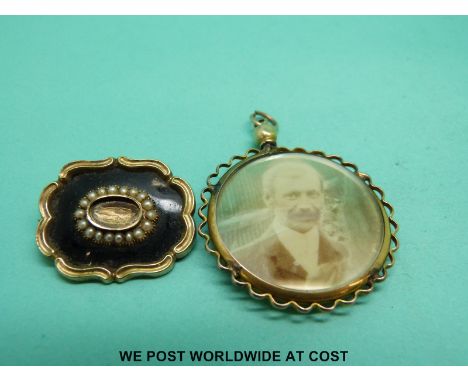 A Victorian yellow metal mourning brooch decorated with black enamel and seed pearls, verso glass compartment and a Victorian