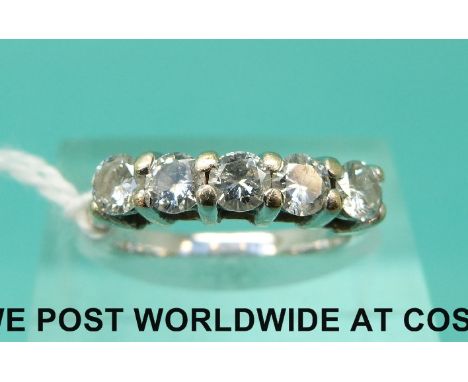 A white metal ring set with five round brilliant cut diamonds (size J)