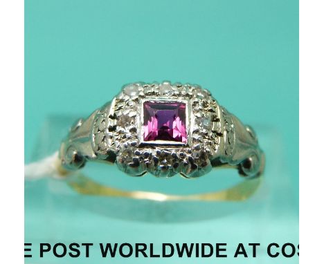 An 18ct gold ring set with a ruby and diamonds in a platinum setting (size K)