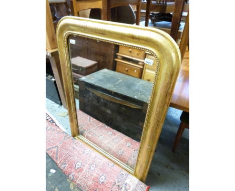 A gilded pine mirror with cushion frame and beaded surround, the frame probably 19th century (H110xW77cm)