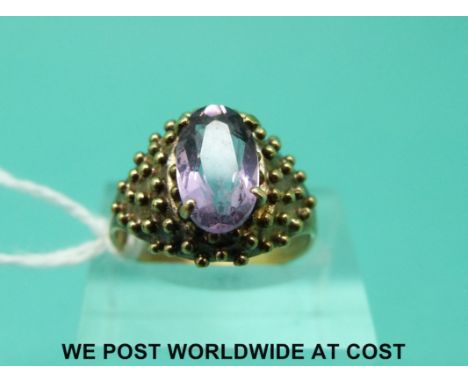 A yellow metal ring marked 333 set with an amethyst (size N)