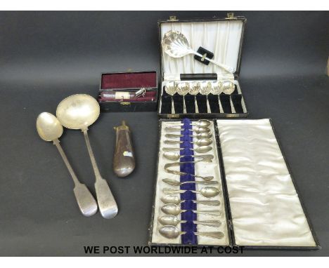 An Elkington & Co plated basting spoon, a cased set of 12 spoons, a ladle, a cased ether syringe and a powder flask