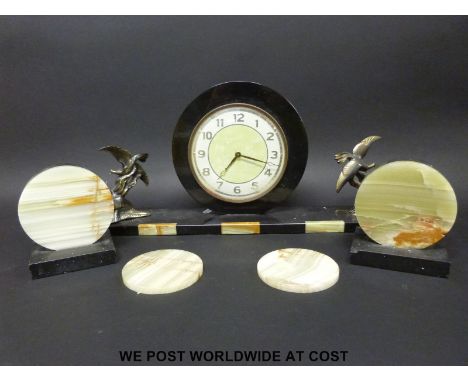 An Art Deco mantel clock garniture with brass bird decoration and inlaid onyx