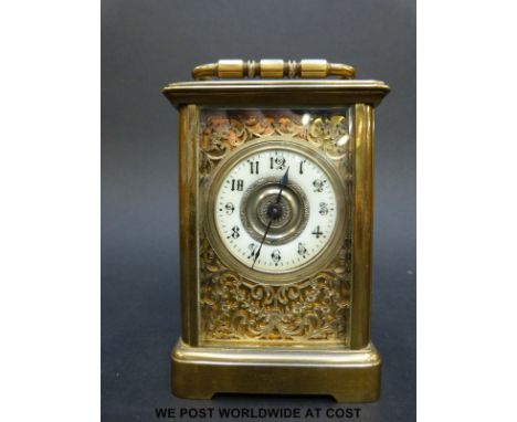 A late 19th/early 20thC brass cased carriage clock with ivory coloured enamel chapter ring, pierced decoration and key (10cm 