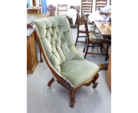 A Victorian upholstered moulded mahogany button back nursing chair raised on brass castors 