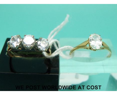 Two 9ct gold rings one with three cubic zirconia (size K) and the other oval cubic zirconia (size P)