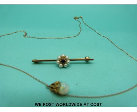 A yellow metal brooch set with an amethyst surrounded by pearls together with a yellow metal pendant on chain 