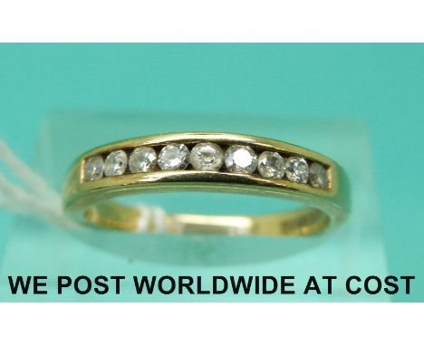 A 9ct gold ring set with nine diamonds in a row (size K/L)