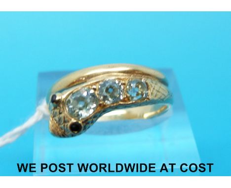 A Victorian ring in the form of a snake, set with three old mine cut diamonds with a blue hue and with jet eyes, 4.3g 
