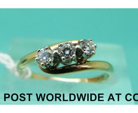 A 9ct gold ring set with three diamonds in a twist setting (size M)