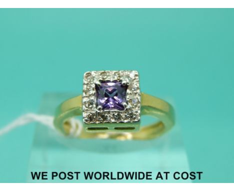 An 18ct gold ring set with an amethyst surrounded by diamonds in a square setting (size L)