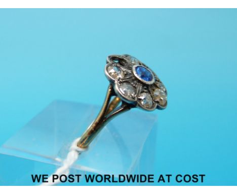 A Victorian 18ct gold ring set with a sapphire surrounded by diamonds (size K)