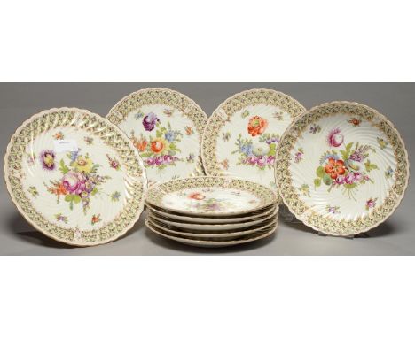 A GERMAN SPIRALLY FLUTED PORCELAIN DESSERT SERVICE, EARLY 20TH C, FREELY PAINTED WITH LOOSE BOUQUETS AND SCATTERED FLOWERS IN