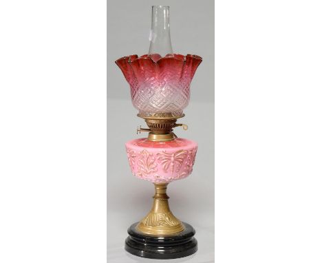 A VICTORIAN MOULDED GLASS OIL LAMP, C1890, THE SHADED PINK GLASS FOUNT WITH BUTTERFLIES AND LEAVES PICKED OUT IN GILT, BRASS 
