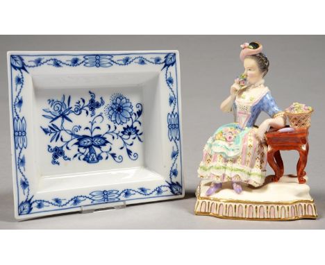 A CONTINENTAL PORCELAIN FIGURE OF A YOUNG GIRL EMBLEMATIC OF SMELL FROM THE FIVE SENSES, ORIGINALLY MODELLED BY J C SCHOENHEI