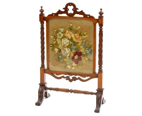 A VICTORIAN MAHOGANY FIRESCREEN, C1870,&nbsp; WITH BERLIN RAISED WOOLWORK FLORAL BANNER AND SPIRALLY REEDED UPRIGHTS WITH FIN