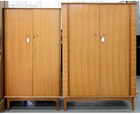 A GRADUATED PAIR OF ALFRED COX WALNUT WARDROBES, MID-CENTURY, 180CM H; 24 X 54CM AND 171CM H; 93 X 56CM, MAKER'S EMBOSSED AC 