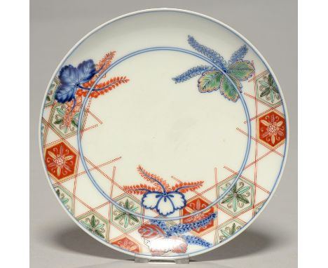 A JAPANESE PORCELAIN DISH, 20TH C, NABESHIMA STYLE, PAINTED WITH TRELLIS ON COMB FOOT, 18.5CM DIAM Condition report  &nbsp;Go