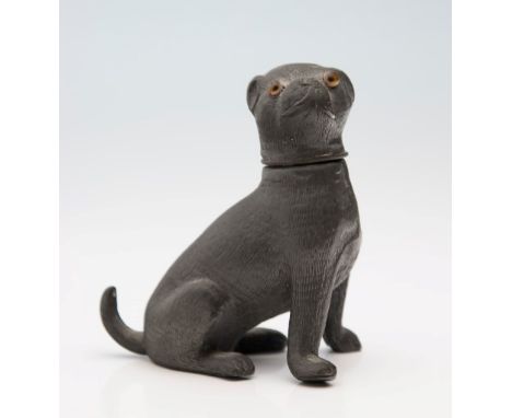 A Victorian pewter seated pug pounce pot/sander, with perforated head and applied glass eyes, 11cm long