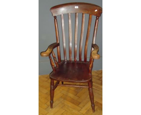 A 19th century beech and elm lathe back Windsor armchair, on ring turned slightly splayed legs
