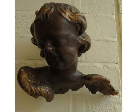 An early 18th century carved lime and gilt gesso winged putto architectural fragment,29 x 27cm