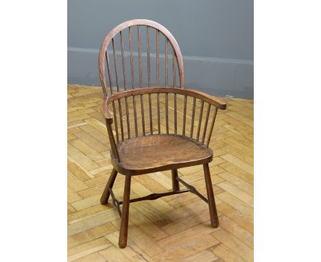 A 19th century beech and elm double hoop and stick back child's Windsor armchair, with shaped seat on splayed turned legs uni