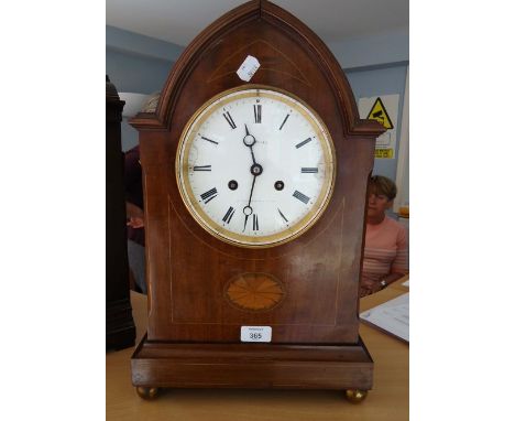 A late 19th century French two train mantel clock, with inlaid mahogany lancet arched form, the Roman numeral marked dial bea